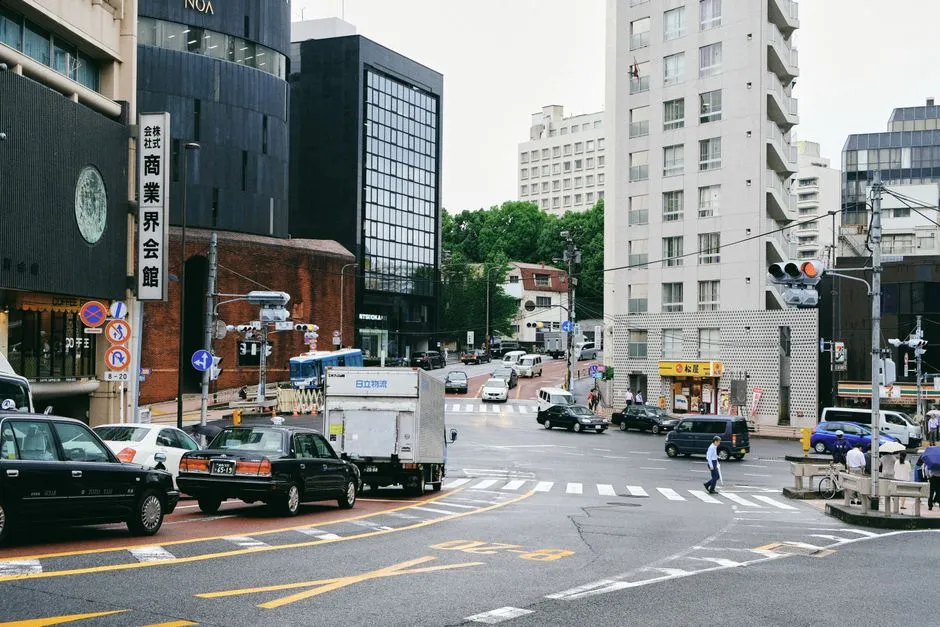 Busy downtown street intersection with vehicles and pedestrians