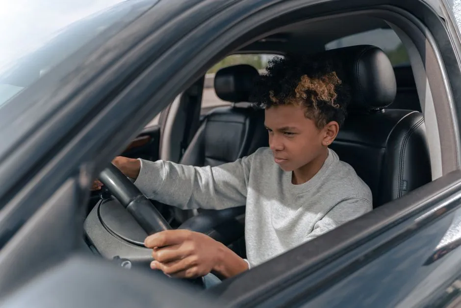Teen driver gripping the steering wheel while practicing behind the wheel